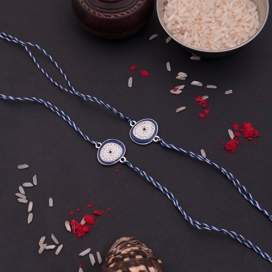 Silver Oval Evil Eye Rakhi Blue Thread Pack of 2